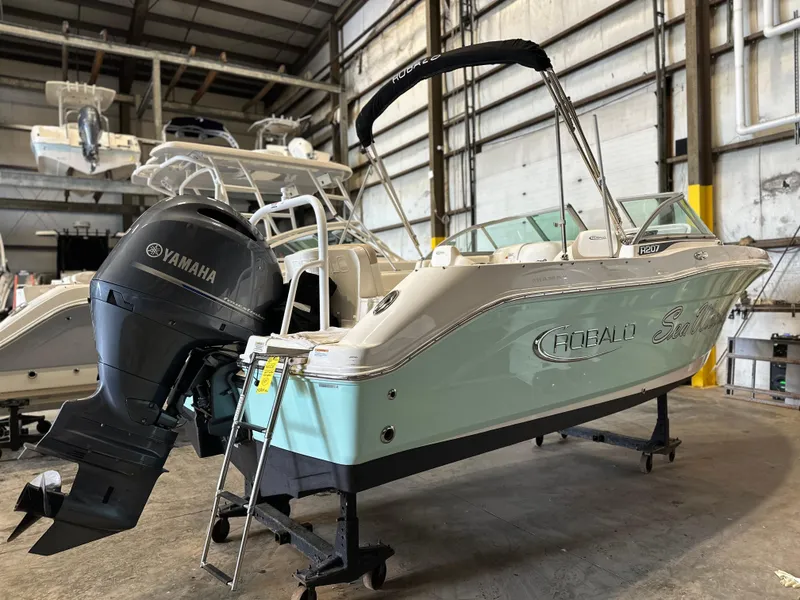 Slide: The Image of 2019 Robalo R207 Dual Console boat with Yamaha engine in a storage facility. - 3