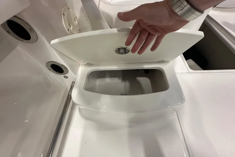 Slide: The Image of 2019 Robalo R207 Dual Console boat storage compartment with open lid. - 30