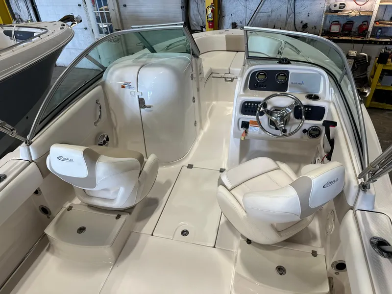 Slide: The Image of 2019 Robalo R207 Dual Console boat interior with white seating and steering console. - 7