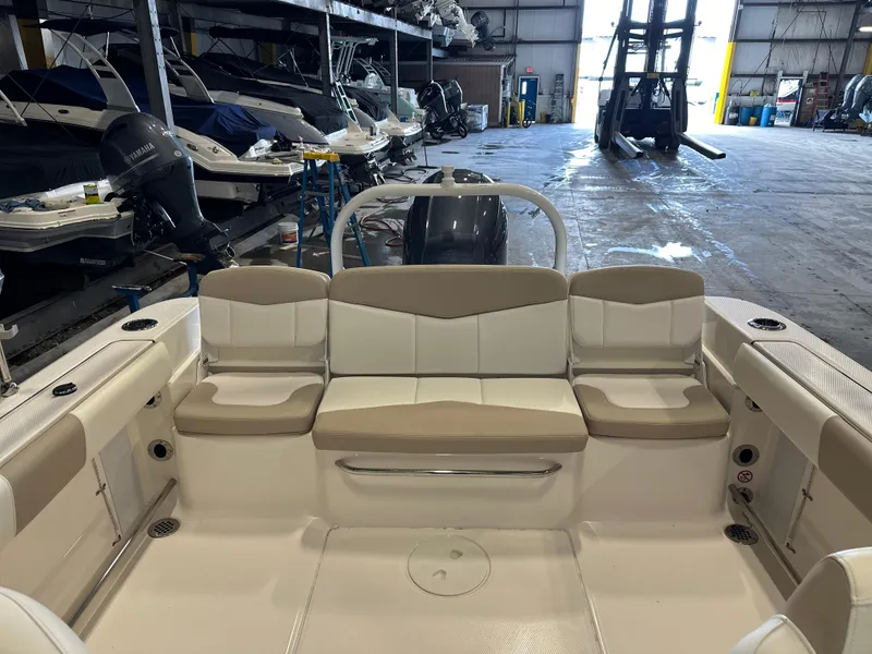 Slide: The Image of 2019 Robalo R207 Dual Console boat interior with beige seating in storage facility. - 8