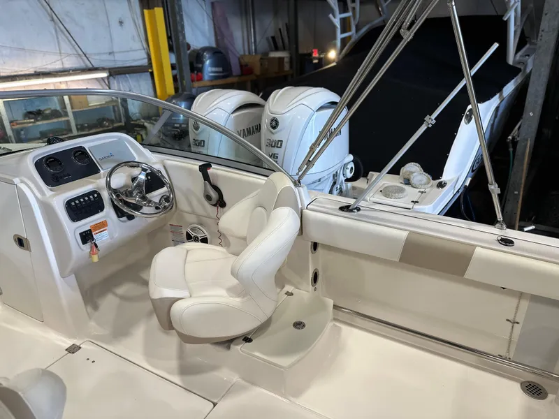 Slide: The Image of 2019 Robalo R207 Dual Console boat interior with steering wheel and Yamaha engines. - 9