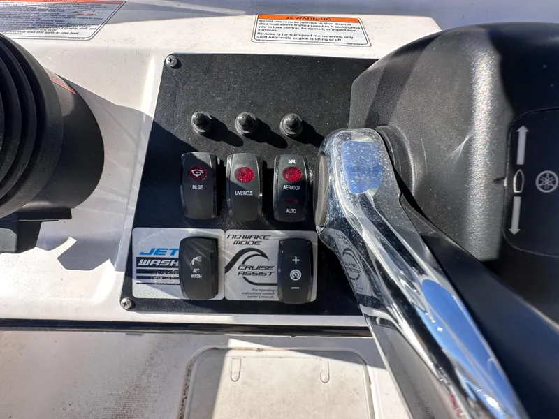 Slide: The Image of Control panel of 2017 Yamaha Boats 190 FSH Sport with various switches and throttle. - 11