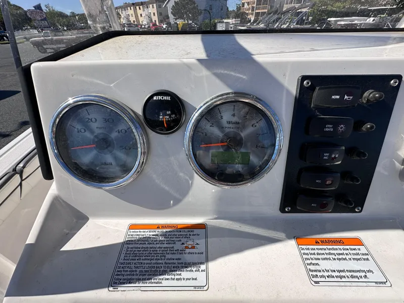 Slide: The Image of Dashboard of 2017 Yamaha Boats 190 FSH Sport with gauges and controls. - 12