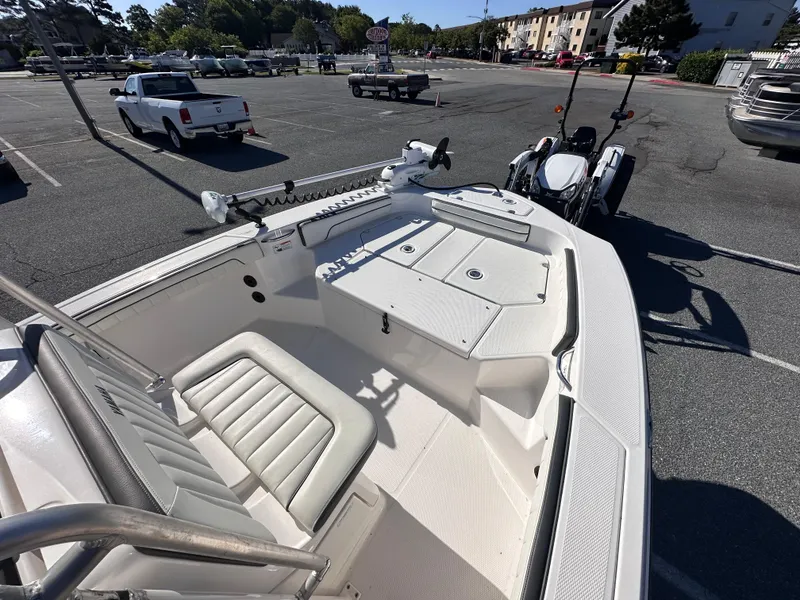 Slide: The Image of 2017 Yamaha Boats 190 FSH Sport in parking lot, showcasing seating and deck layout. - 13