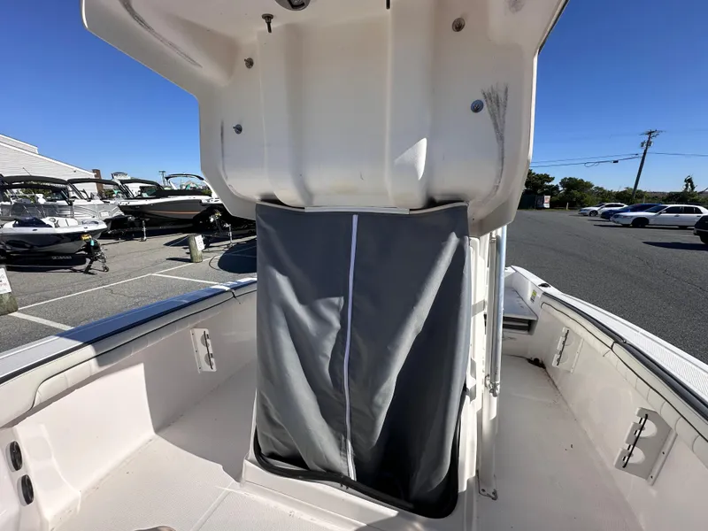 Slide: The Image of 2017 Yamaha Boats 190 FSH Sport interior with storage compartment, outdoor setting. - 16