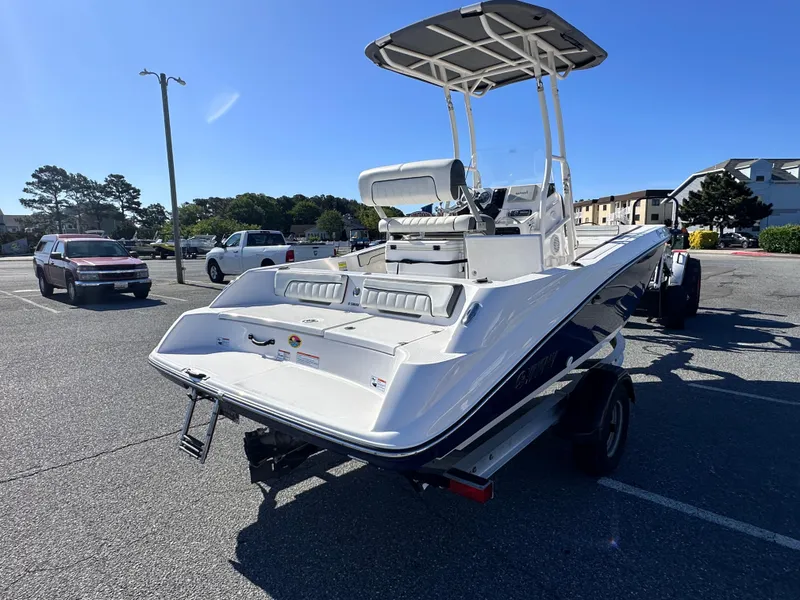 Slide: The Image of 2017 Yamaha Boats 190 FSH Sport in parking lot, rear view, sunny day. - 4