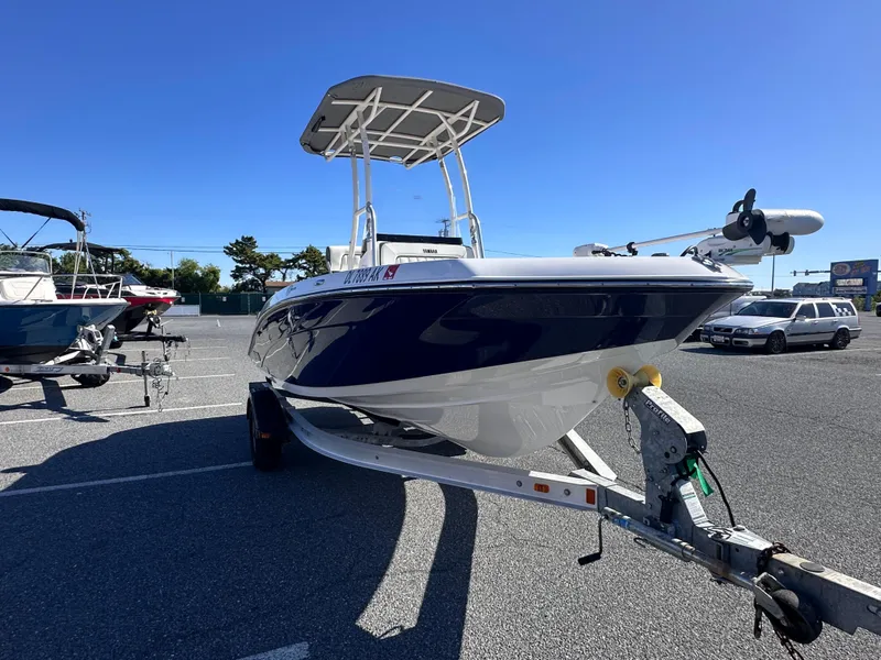 Slide: The Image of 2017 Yamaha Boats 190 FSH Sport on trailer in parking lot under clear blue sky. - 6