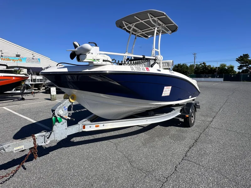 Slide: The Image of 2017 Yamaha Boats 190 FSH Sport on trailer in parking lot, clear sky background. - 7