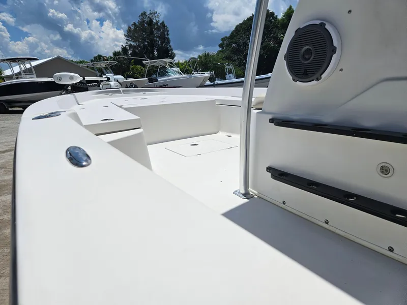 Slide: The Image of 2011 Pathfinder 2400 Tournament Edition boat interior with seating and speaker, under a partly cloudy sky. - 10