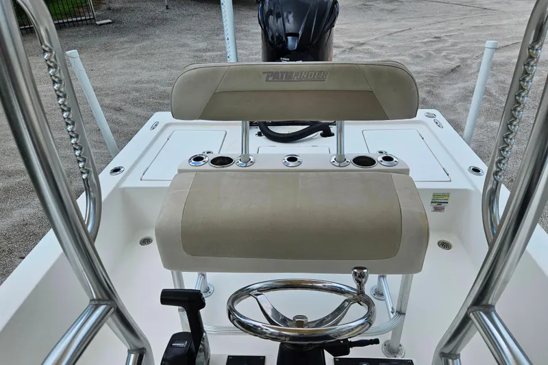 Slide: The Image of 2011 Pathfinder 2400 Tournament Edition boat interior with steering wheel and seating. - 12