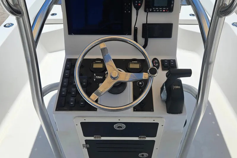 Slide: The Image of Control console of a 2011 Pathfinder 2400 Tournament Edition boat with steering wheel and navigation equipment. - 14