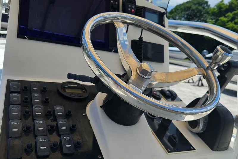 Slide: The Image of Steering wheel and controls of 2011 Pathfinder 2400 Tournament Edition boat. - 15