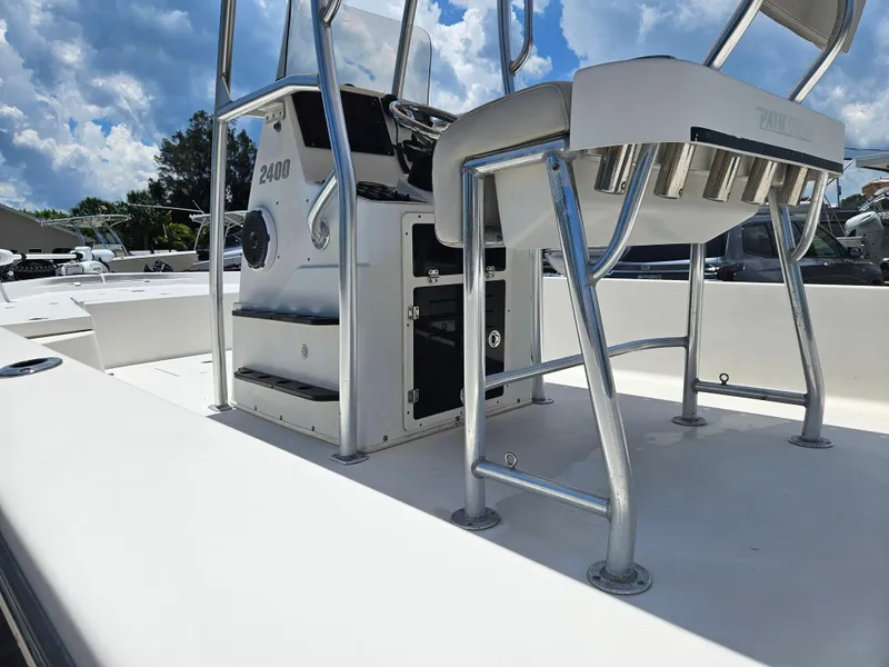 Slide: The Image of 2011 Pathfinder 2400 Tournament Edition boat interior with seating and console, under a clear blue sky. - 16