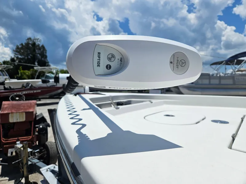 Slide: The Image of 2011 Pathfinder 2400 Tournament Edition boat with Riptide trolling motor under a cloudy sky. - 17