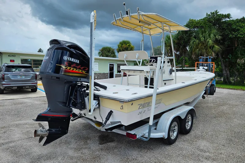 Slide: The Image of 2011 Pathfinder 2400 Tournament Edition boat with Yamaha engine on trailer, parked outdoors. - 2