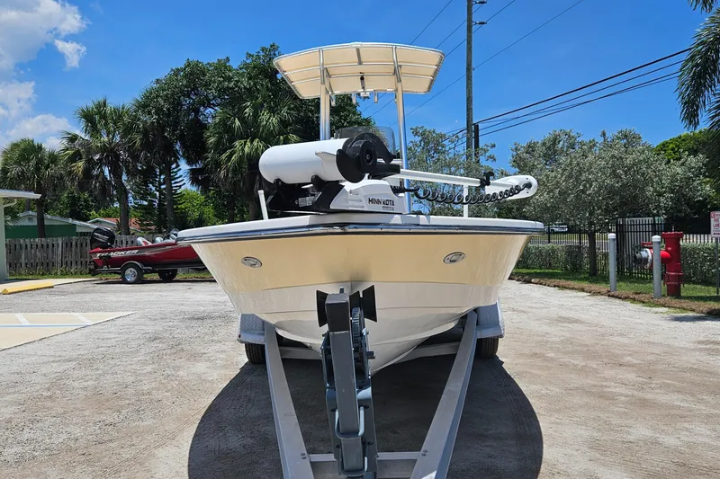 Slide: The Image of 2011 Pathfinder 2400 Tournament Edition boat on trailer, parked outdoors under clear blue sky. - 4
