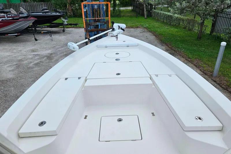 Slide: The Image of 2011 Pathfinder 2400 Tournament Edition boat deck with storage compartments and trolling motor. - 7