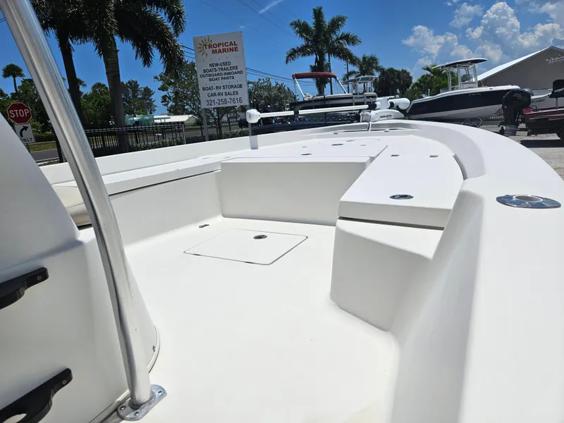 Slide: The Image of 2011 Pathfinder 2400 Tournament Edition boat deck with seating, parked outdoors under clear sky. - 8