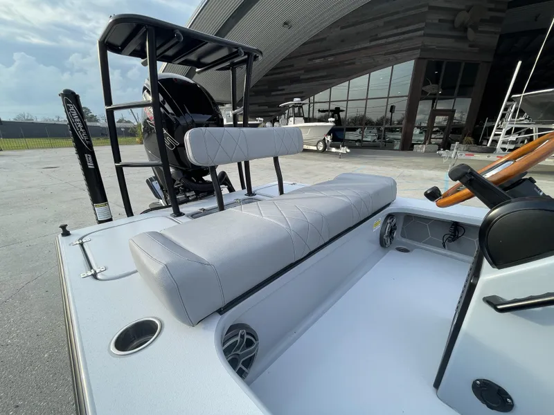 Slide: The Image of 2023 ZCB 18 Curlew boat interior with cushioned seating and steering wheel. - 11