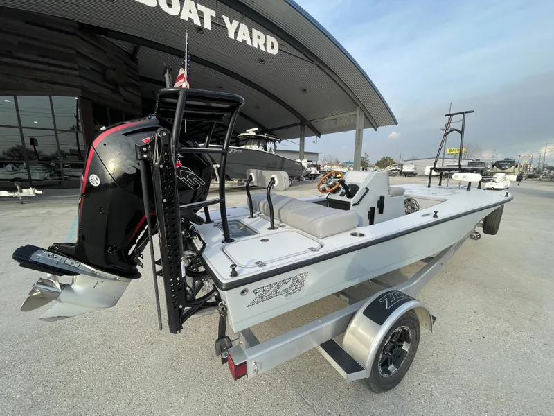 Slide: The Image of 2023 ZCB 18 Curlew boat at a boat yard, featuring a sleek design and powerful engine. - 3