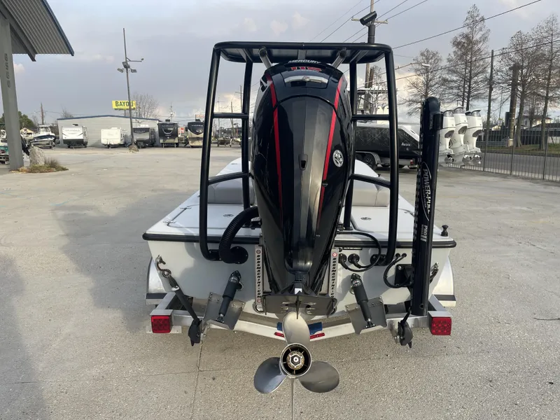 Slide: The Image of 2023 ZCB 18 Curlew boat with Mercury outboard motor, rear view in a marina. - 6