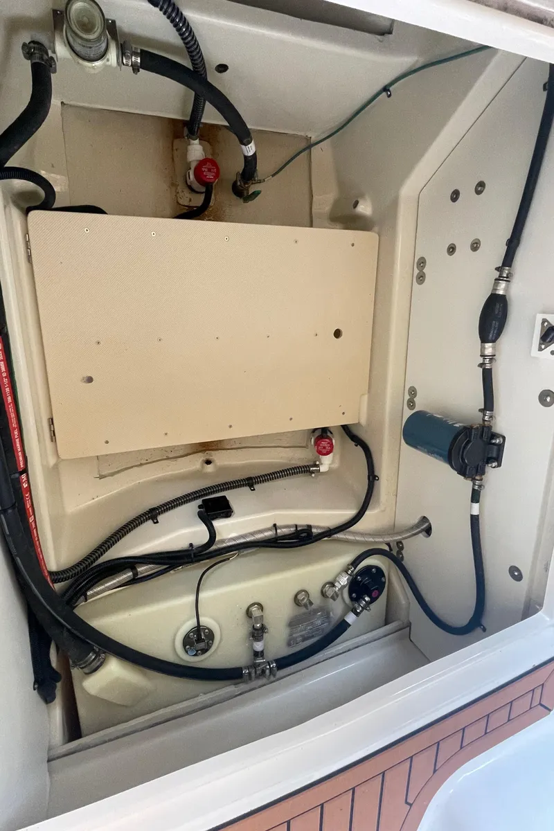 Slide: The Image of 2023 Ranger Tugs R-25 engine compartment with visible wiring and components. - 16