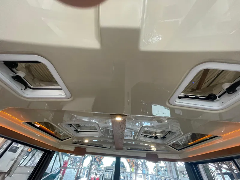 Slide: The Image of Ceiling view of 2023 Ranger Tugs R-25 boat interior with hatches and lighting. - 20