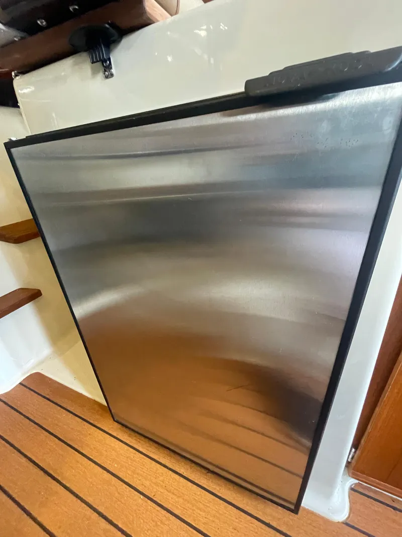 Slide: The Image of Stainless steel refrigerator on 2023 Ranger Tugs R-25 boat interior. - 24