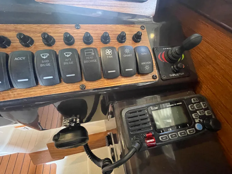 Slide: The Image of Control panel of 2023 Ranger Tugs R-25 with switches and communication device. - 28