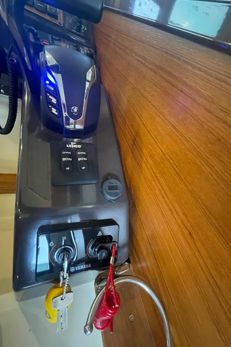 Slide: The Image of Control panel of 2023 Ranger Tugs R-25 boat with Yamaha controls and keys. - 30