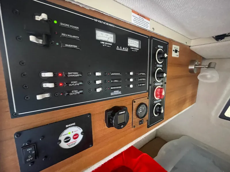 Slide: The Image of Control panel of 2023 Ranger Tugs R-25 boat with switches and gauges. - 33