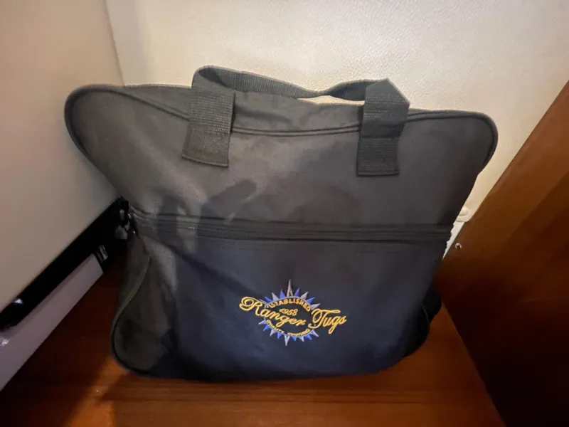 Slide: The Image of Black Ranger Tugs bag on wooden floor, featuring embroidered logo. - 41