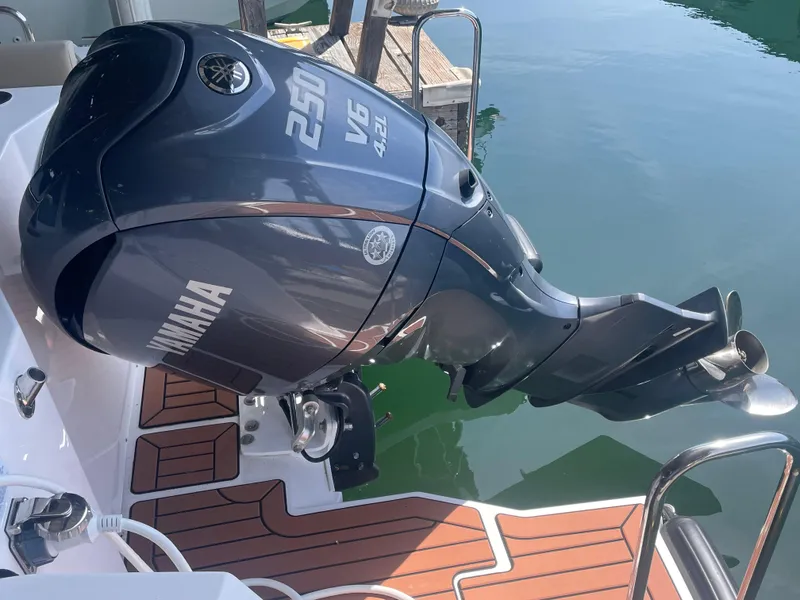 Slide: The Image of Yamaha 250 outboard motor on 2023 Ranger Tugs R-25 boat, docked on water. - 6