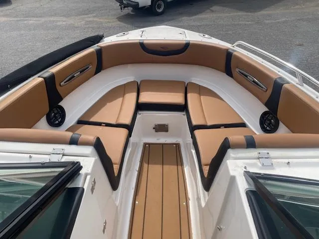 Slide: The Image of 2023 Chaparral 247 SSX boat interior with tan seating and sleek design. - 5