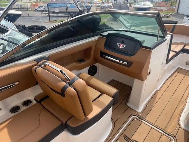 Slide: The Image of 2023 Chaparral 247 SSX boat interior with tan leather seats and sleek dashboard design. - 6