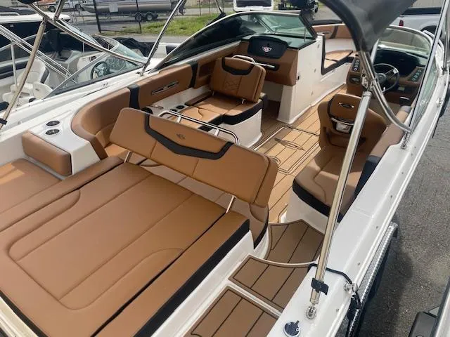 Slide: The Image of 2023 Chaparral 247 SSX boat interior with tan seating and sleek design. - 8