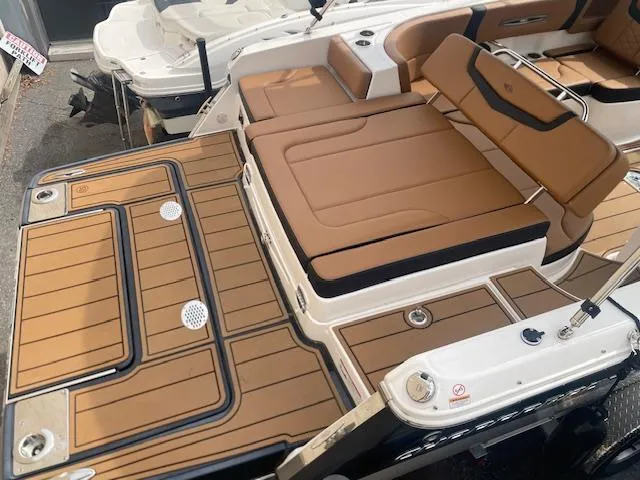 Slide: The Image of 2023 Chaparral 247 SSX boat with tan seating and deck, showcasing luxury design. - 9