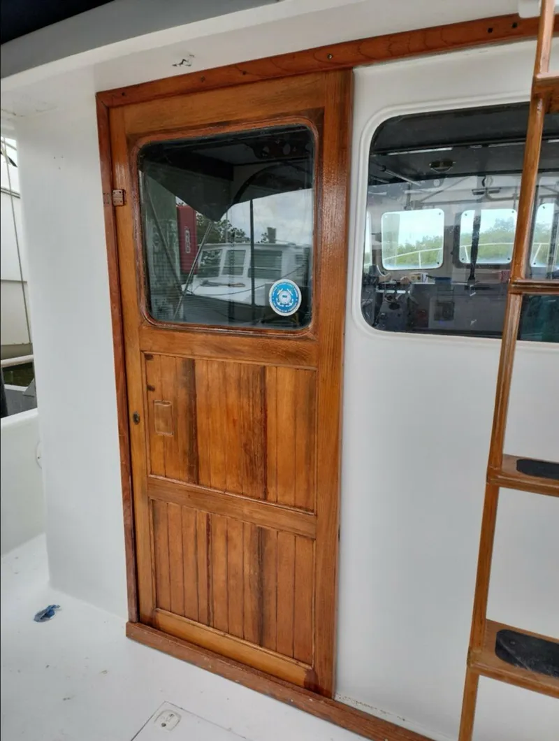 Slide: The Image of 1973 CHB Trawler wooden cabin door with window and ladder. - 13