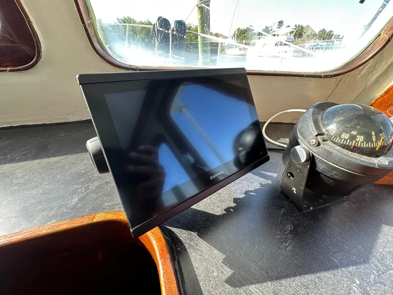 Slide: The Image of 1973 CHB Trawler dashboard with Garmin screen and compass in sunlight. - 20