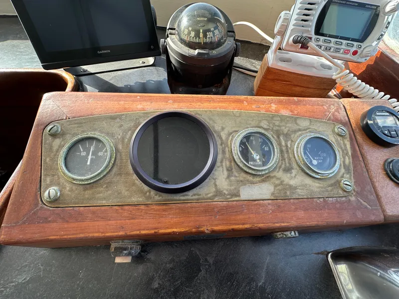 Slide: The Image of 1973 CHB Trawler dashboard with vintage gauges and navigation equipment. - 21