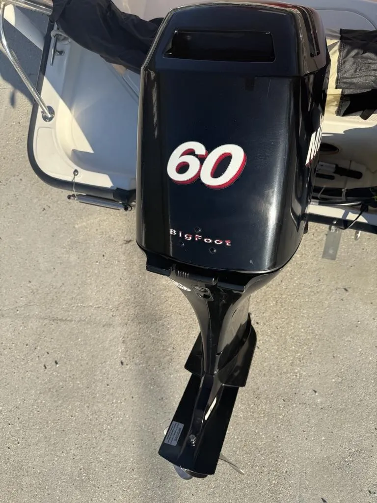 Slide: The Image of Outboard motor on a 2007 Boston Whaler 150 Montauk boat, featuring "60 BigFoot" branding. - 11