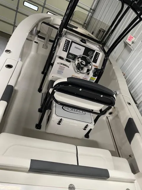 Slide: The Image of 2025 Robalo R202 Explorer boat interior with steering console and seating. - 3