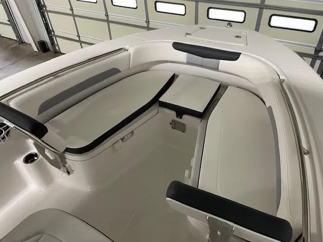 Slide: The Image of 2025 Robalo R202 Explorer boat interior with cushioned seating and storage compartments. - 4