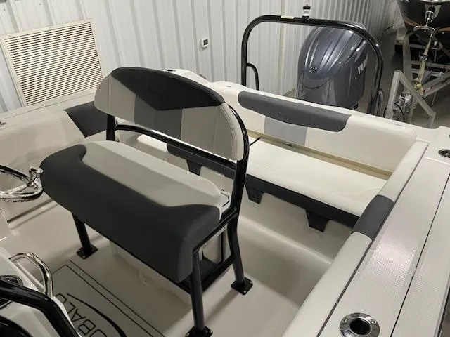 Slide: The Image of 2025 Robalo R202 Explorer boat interior with seating and engine view. - 7