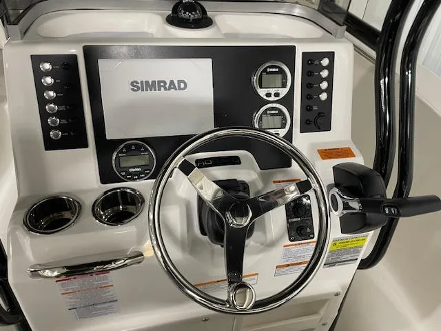 Slide: The Image of 2025 Robalo R202 Explorer dashboard with Simrad display and controls. - 9