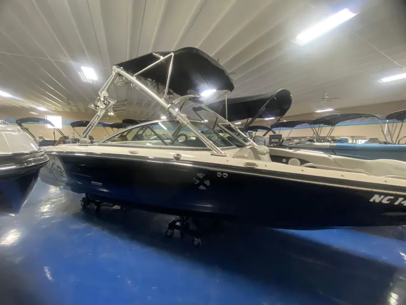 Slide: The Image of 2008 MasterCraft X 45 boat in showroom, featuring sleek design and bimini top. - 1