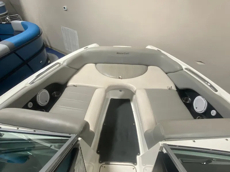 Slide: The Image of 2008 MasterCraft X 45 boat interior with gray seating and built-in speakers. - 3