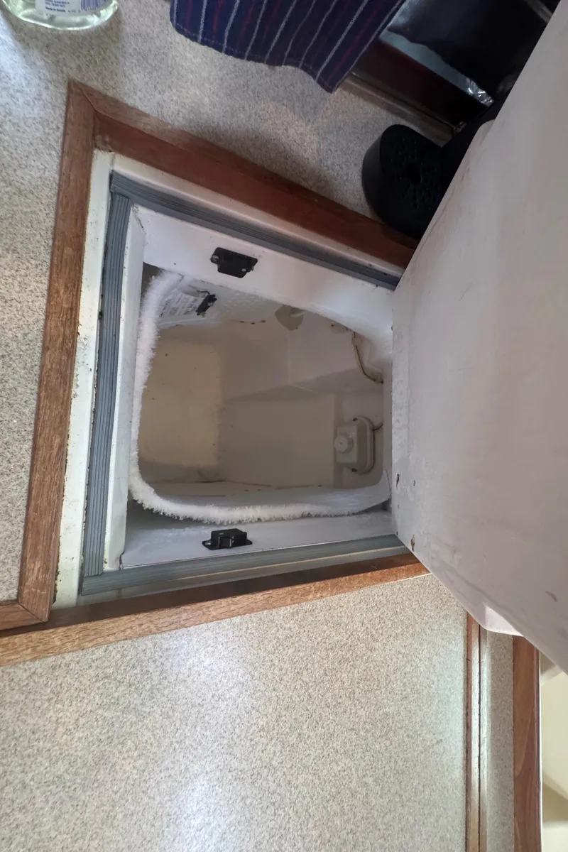 Slide: The Image of Built-in storage compartment on a 1998 Hunter 410 boat interior. - 10