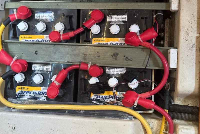 Slide: The Image of Battery compartment with red and yellow cables in a 1998 Hunter 410 model. - 17