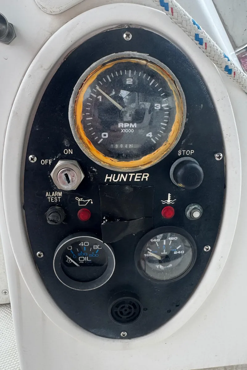 Slide: The Image of Control panel of a 1998 Hunter 410 boat with RPM and oil gauges. - 21